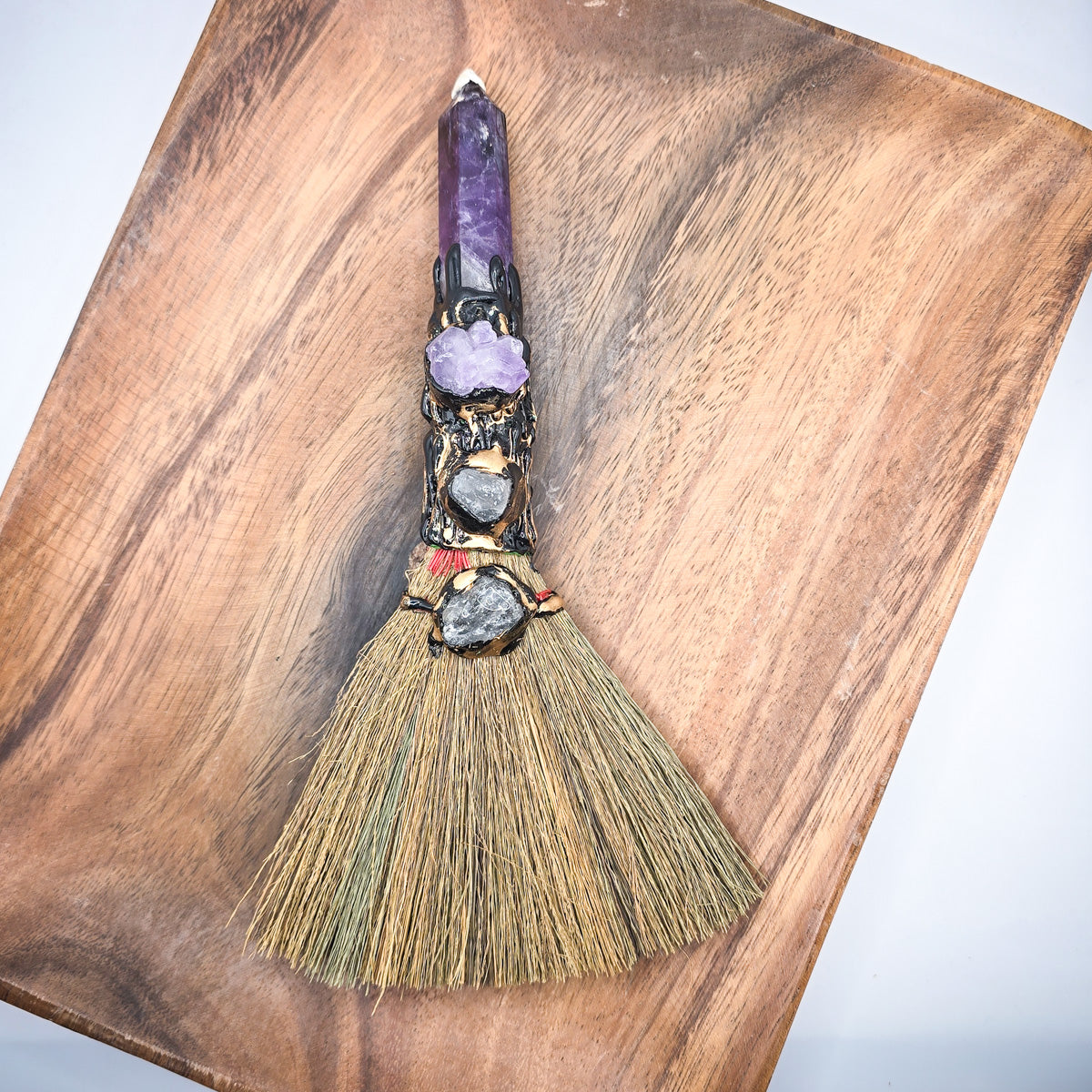 Crystal Harmony Sweep displayed on wooden plank, natural crystal and amethyst crystal point visible.