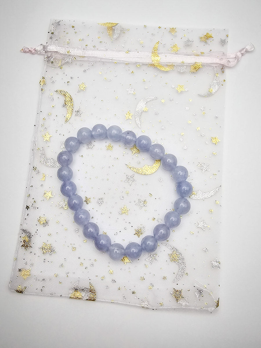 Aquamarine bracelet gracefully arranged on its storage bag, showing the thoughtful packaging and the bracelet's soothing hues.