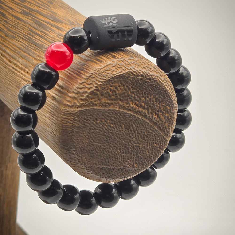 Aries-themed charm bracelet on wooden stand, showcasing beads with the ram and Aries symbol for astrological insight.