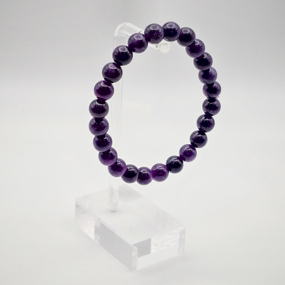 Elegant Amethyst Bracelet Displayed on Acrylic Stand - A Beacon of Peace and Balance