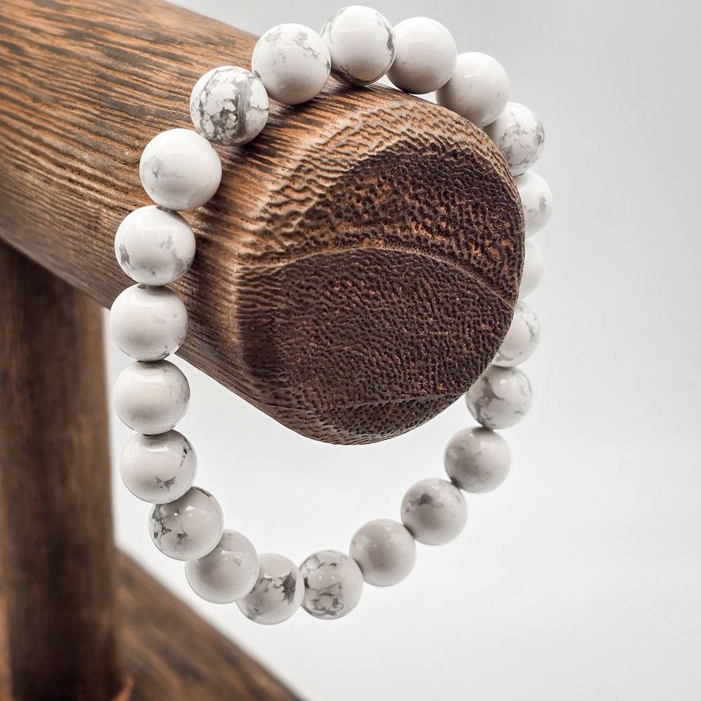 Howlite Beaded Bracelet on Wood Stand - Embodying Serenity and Understanding