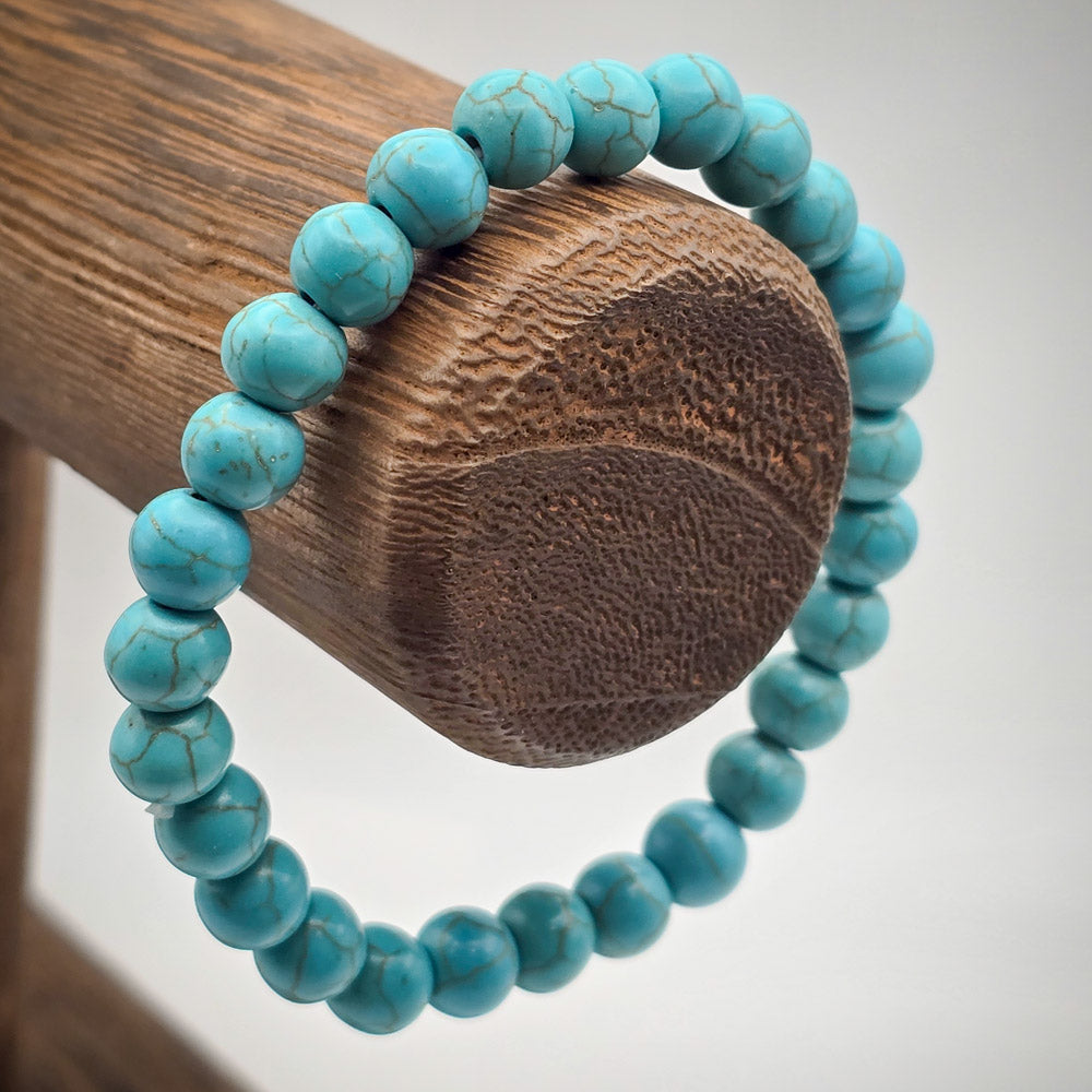 Turquoise Beaded Bracelet on Wood Stand - A Beacon of Protection and Success