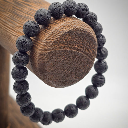 Lava Stone Beaded Bracelet on Wood Stand - Emblem of Strength and Stability