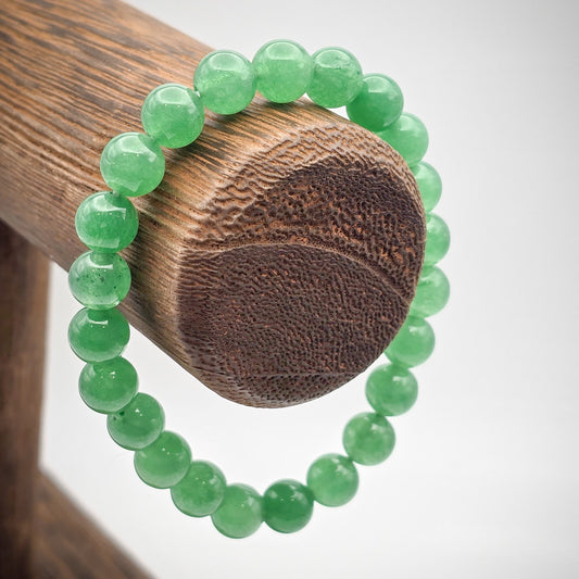 Green Aventurine Beaded Bracelet on Wood Stand - Harmony and Prosperity.