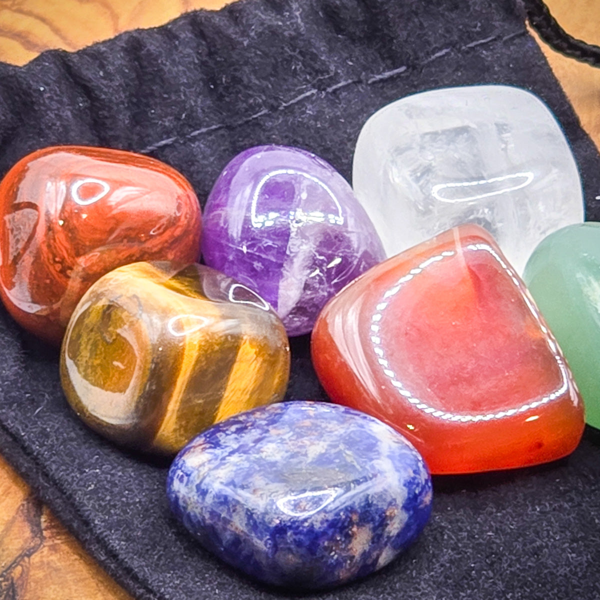 Detailed view of chakra stones for the necklace in a black velvet pouch