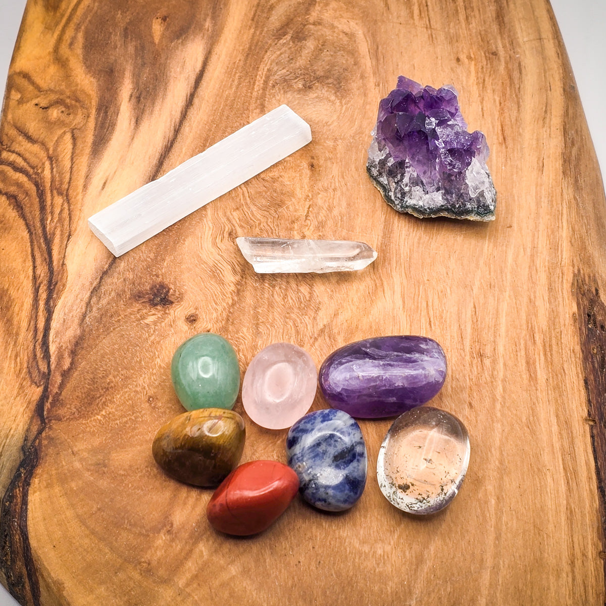 Overview of the Natural Crystal Chakra Set on a wooden surface