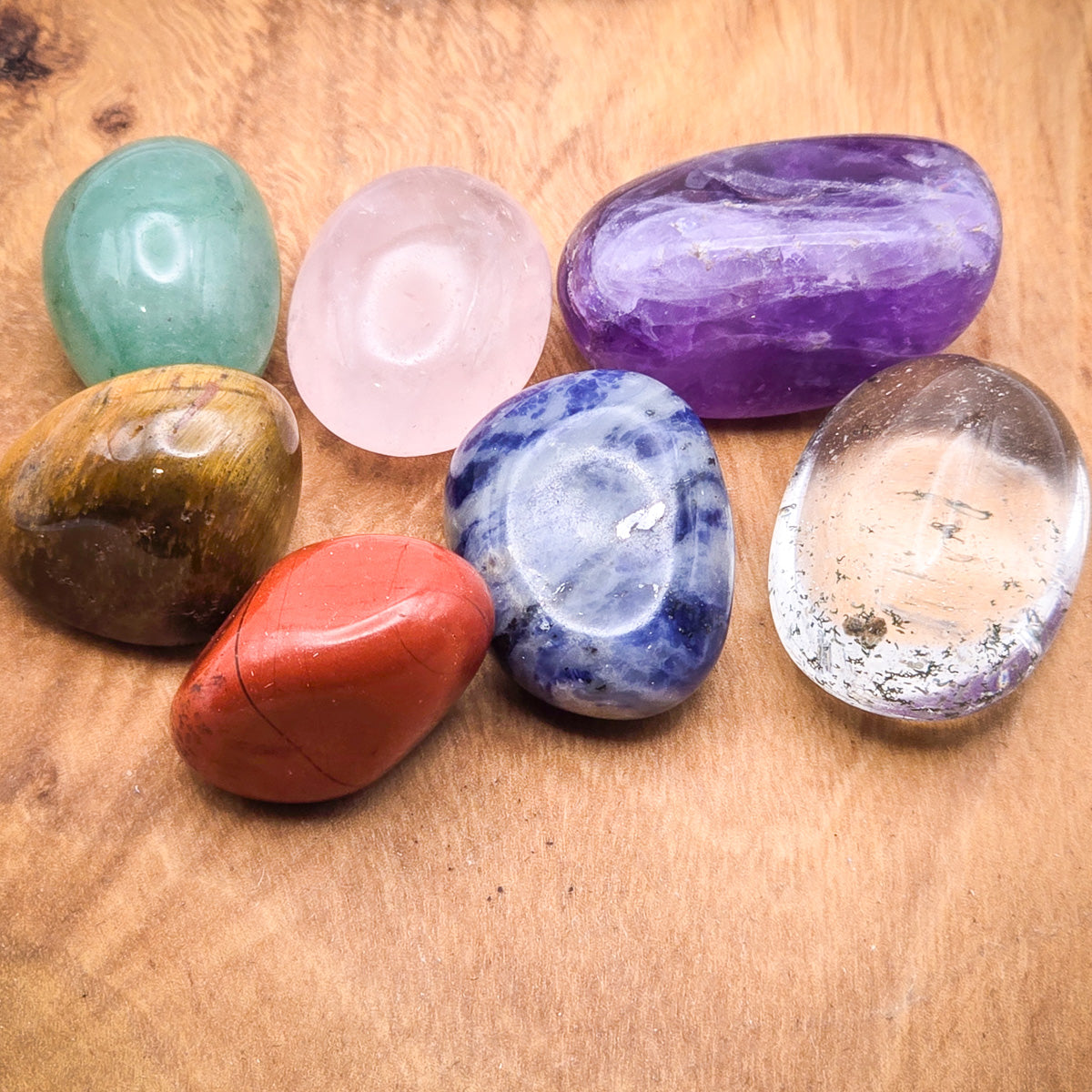 Close-up of the seven chakra stones on wood