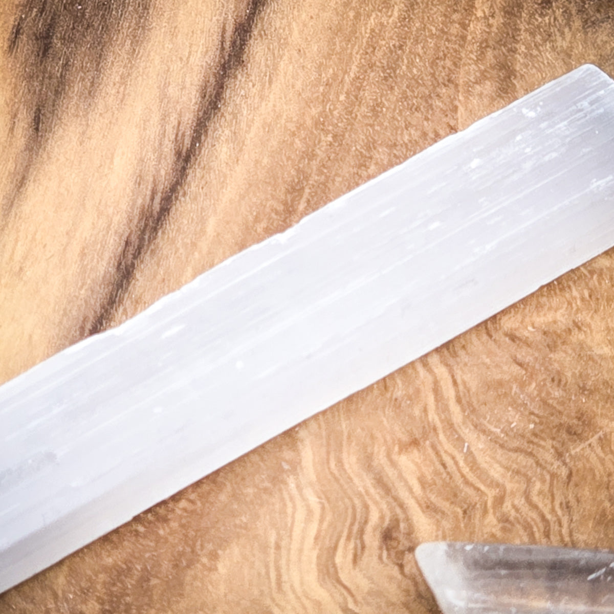 Selenite crystal close-up on a wooden background