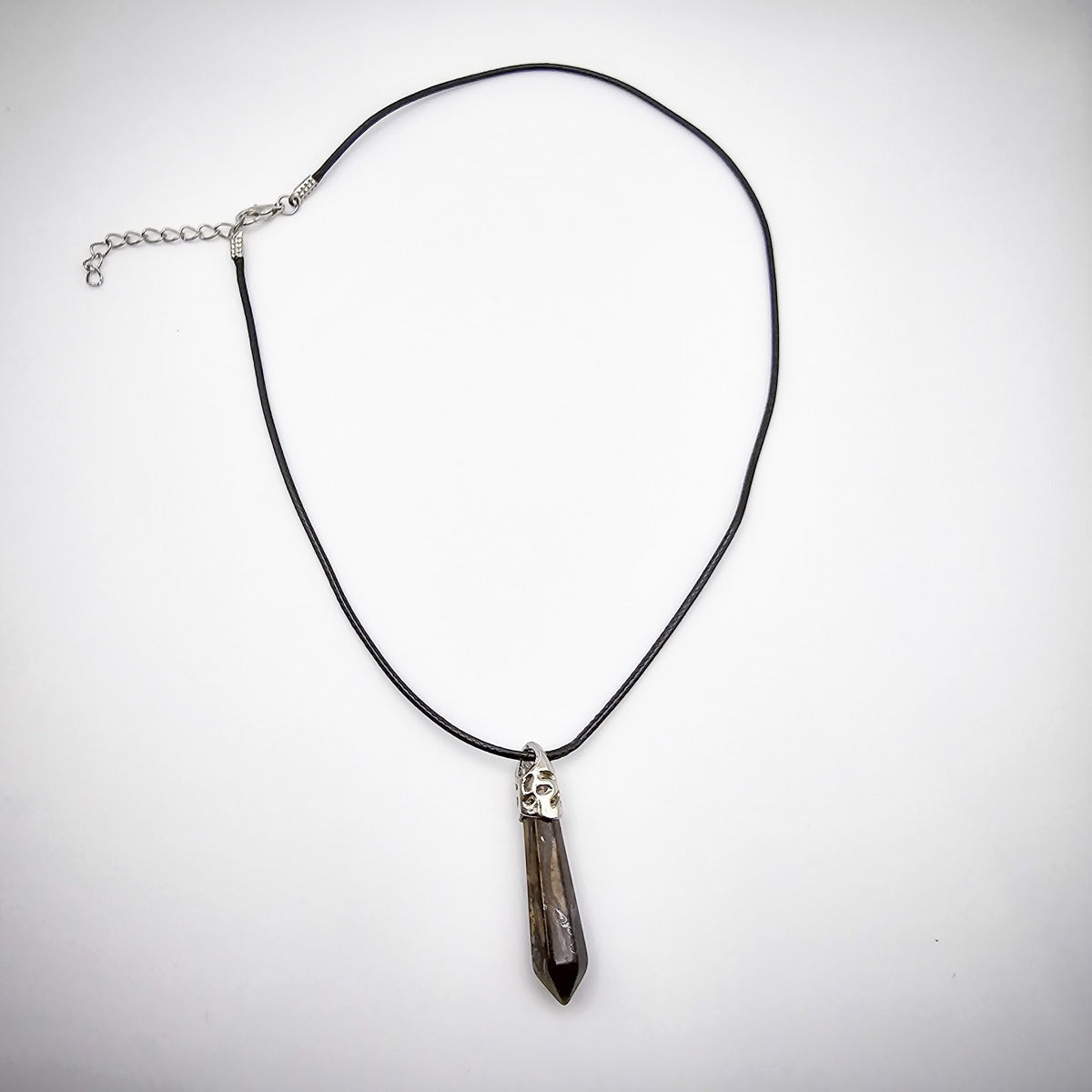 Full view of the Tiger's Eye pendant necklace against a white background, highlighting the sleek black cord and the pendant's natural elegance.