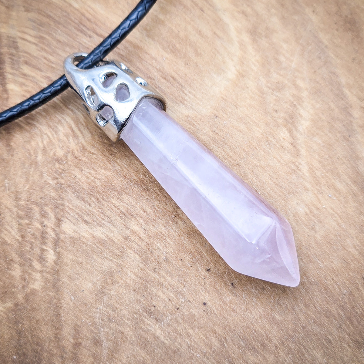 Close-up view of the Rose Quartz hexagonal pendant, showcasing the stone's gentle pink color and smooth, geometric elegance.