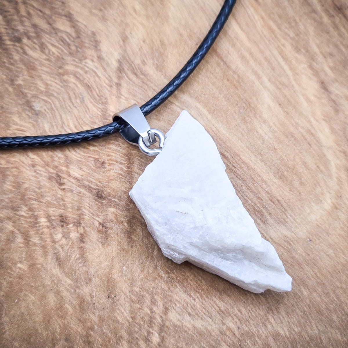 Detailed view of the Moonstone raw pendant, showcasing its ethereal glow and textural beauty