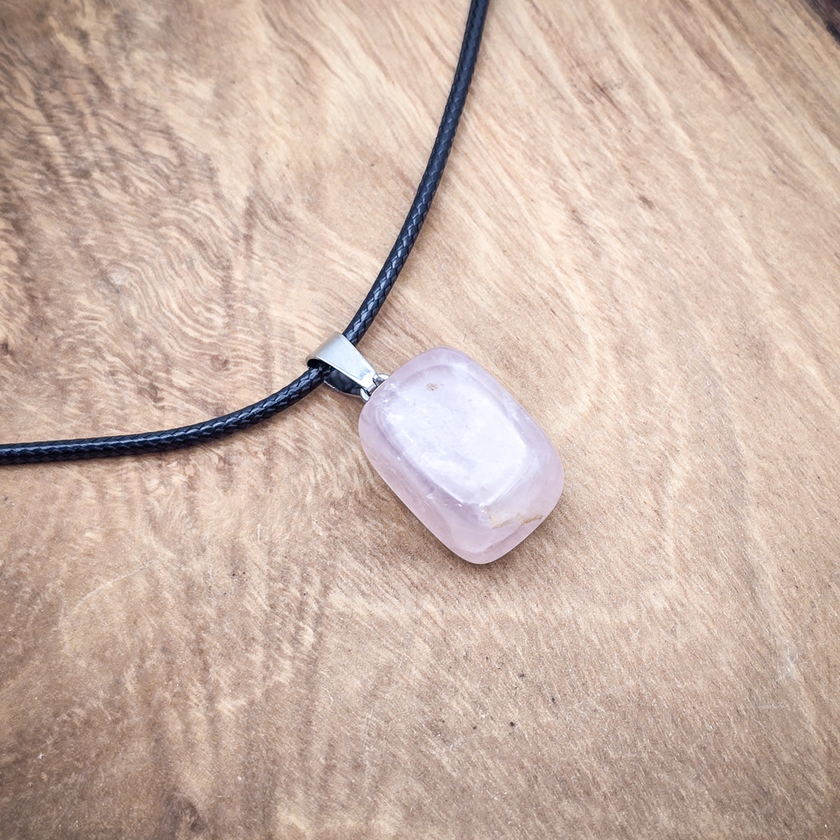 Close-up of the Rose Quartz cube pendant, showcasing its gentle pink hue and polished, geometric simplicity.