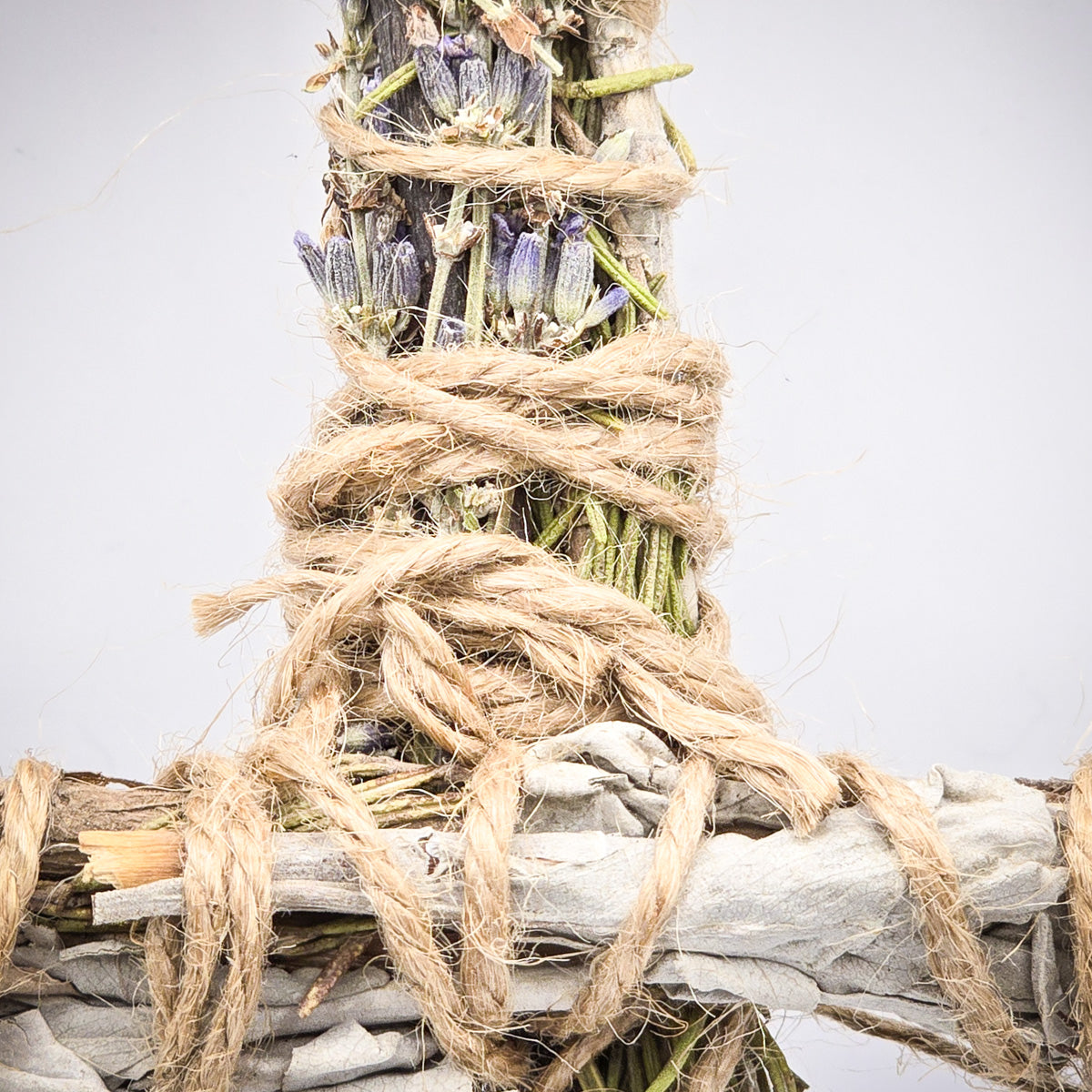 Close-up of the poppet/prayer doll showcasing the hemp string and the detailed herbs of sage, rosemary, and lavender