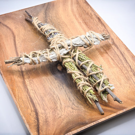 Handmade poppet/prayer doll lying on a wooden tray, crafted from natural herbs