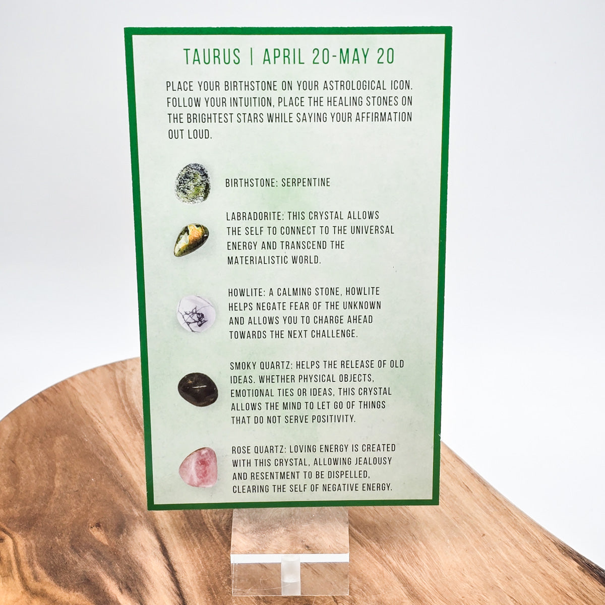 Reverse side of the Taurus card showing what crystals the bag contains.  Sitting on a wood block with white background.