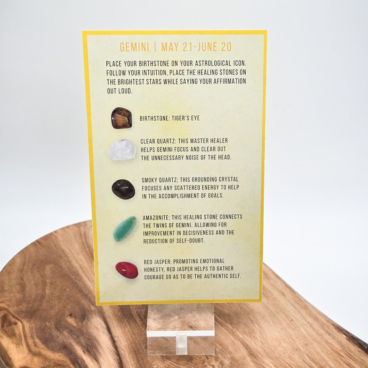 Reverse side of the Gemini card showing what crystals the bag contains.  Sitting on a wood block with white background.