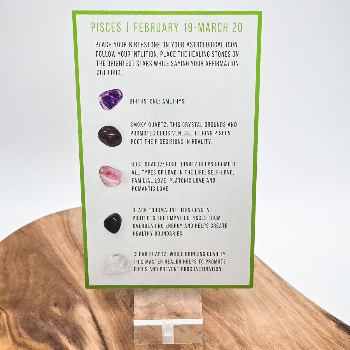 Reverse side of the Pisces card showing what crystals the bag contains.  Sitting on a wood block with white background.