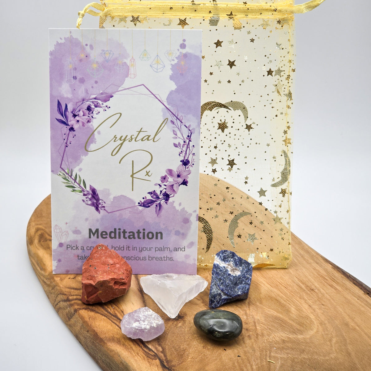 Full spread of 'Meditation & Mindfulness' Mojo Bag contents laid out on wood, showing the variety of crystals meant to support a serene meditation space.