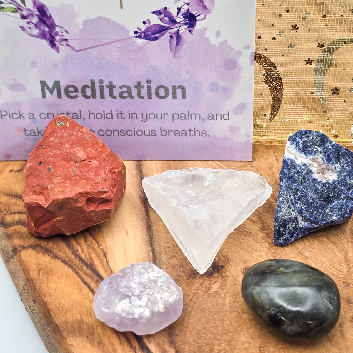 Closeup of the 'Meditation & Mindfulness' Mojo Bag’s crystals alongside the card titled 'Meditation,' merging the beauty of natural stones with mindful practice