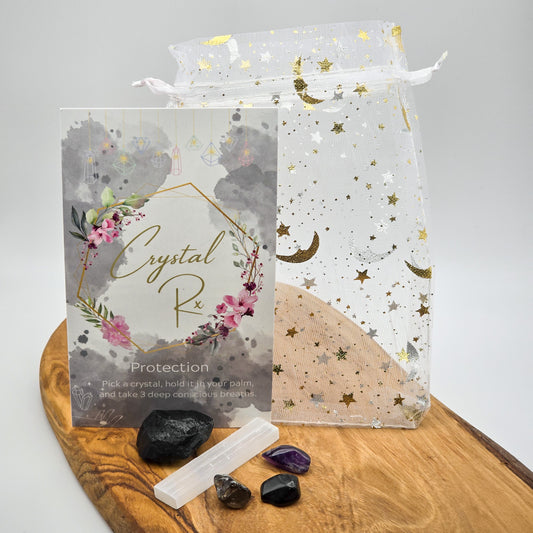 Wide shot of the 'Protection' Mojo Bag contents spread out on a wooden backdrop, representing a comprehensive shield against negative energies.