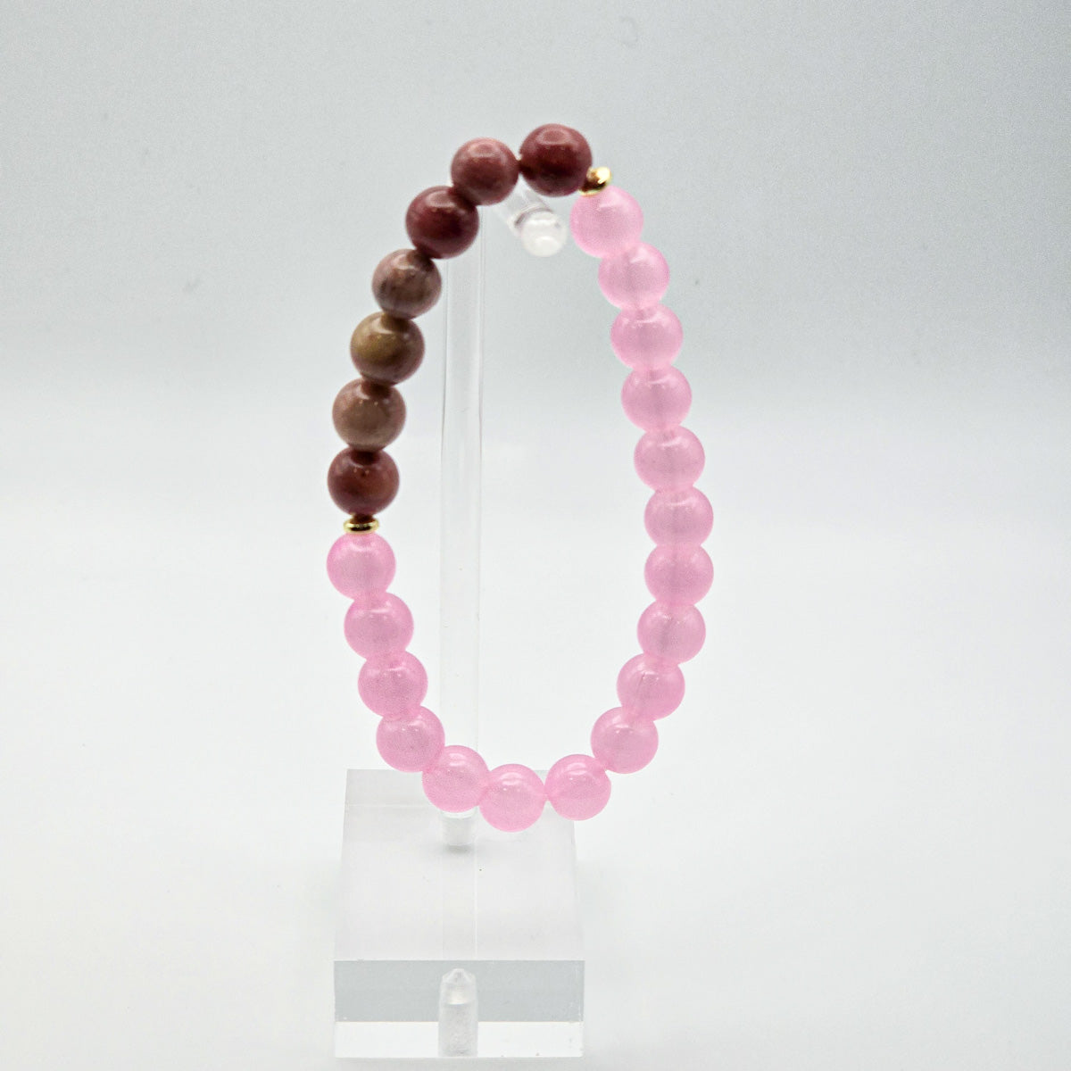 Elegant rhodonite and pink bead bracelet on acrylic - serene style