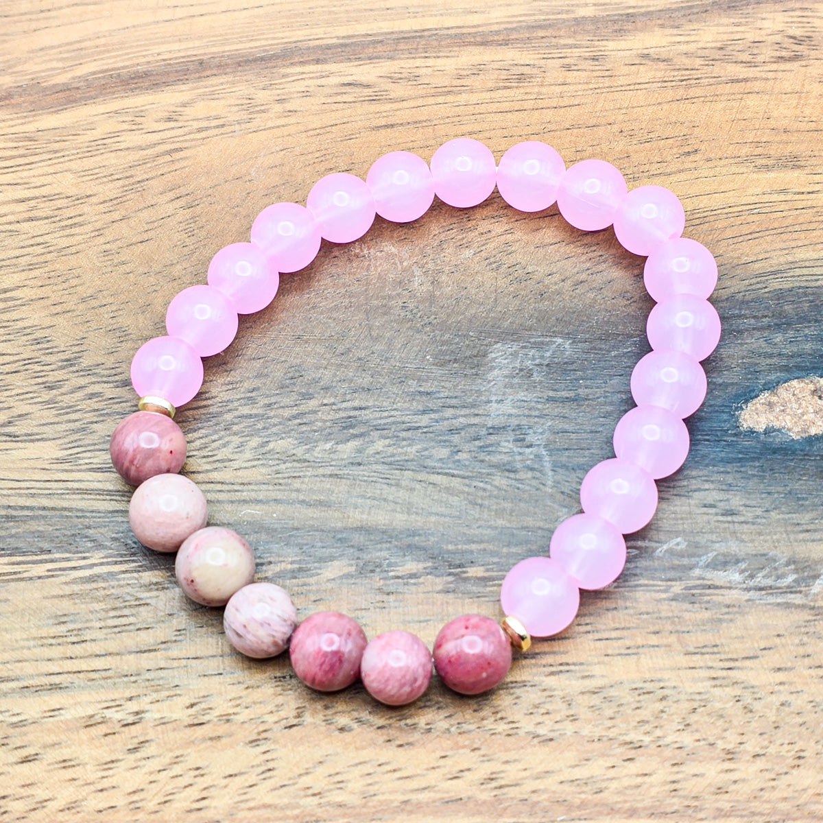 Harmonious blend of rhodonite and pink beads on wood - stylish tranquility