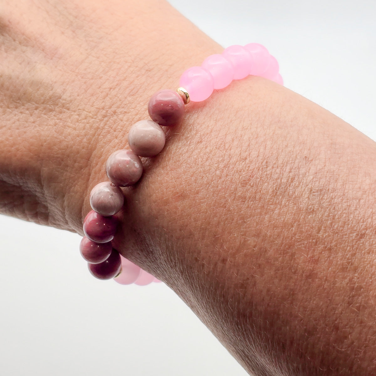 Woman wearing rhodonite and pink bead bracelet - touch of elegance and peace