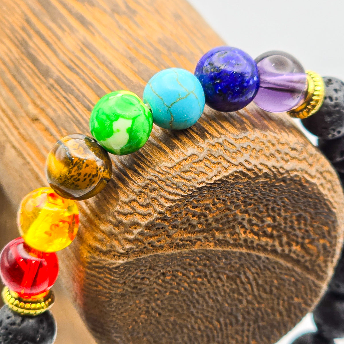 Vibrant chakra beads detail on lava stone bracelet - spiritual alignment