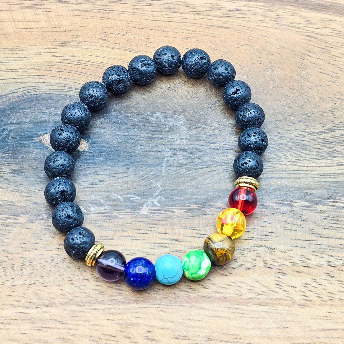 Full view of chakra bracelet on wood - chakra synchronization