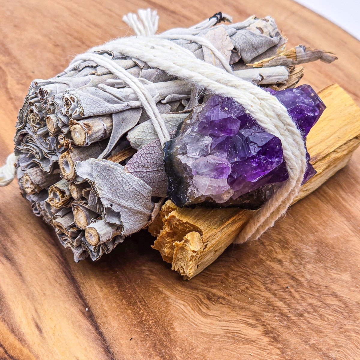 Mini Cleansing Trio on wood, from the left - Sage and Palo Santo with Amethyst