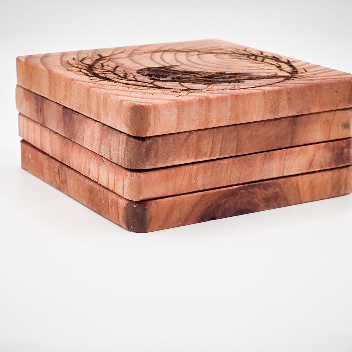 four coasters stacked, from the side angle, showing the details of the wood grain