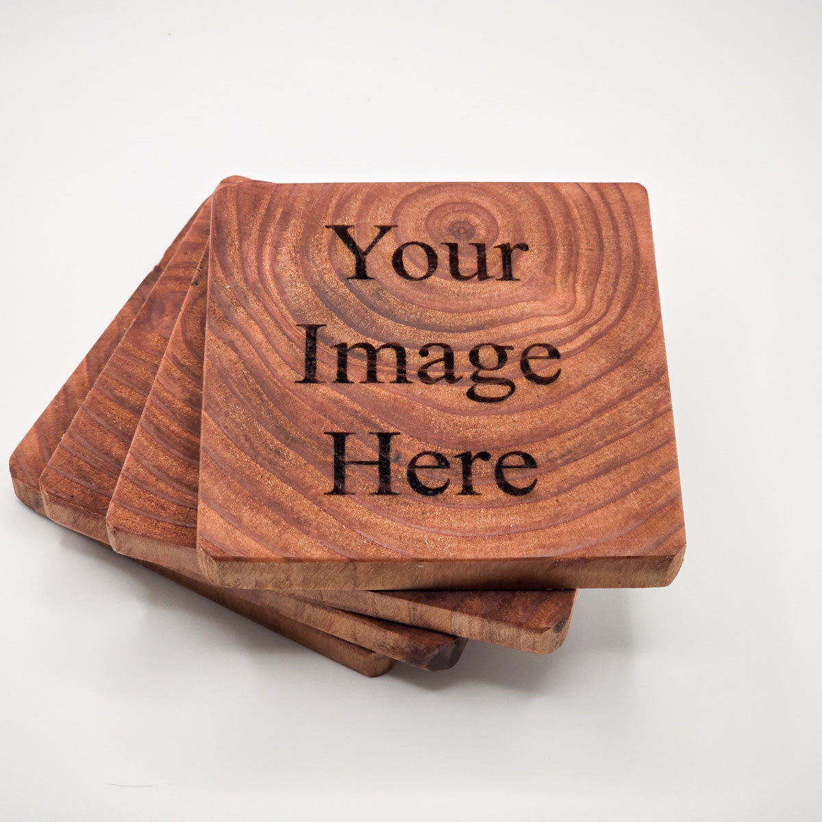 Stack of customizable Redwood Coasters, ideal for personal or corporate gifting.