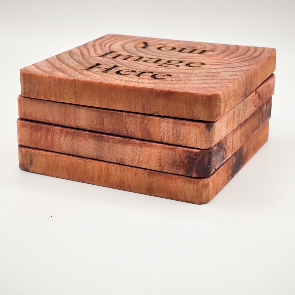 Stack of customizable Redwood Coasters, ideal for personal or corporate gifting, side angle.