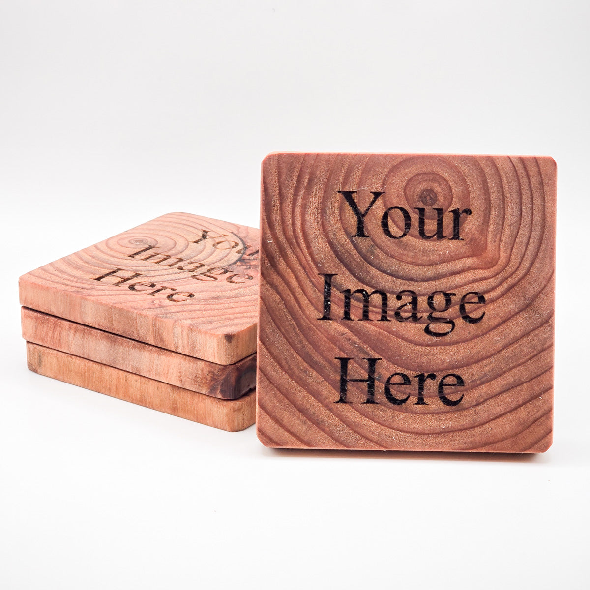 Stack of customizable Redwood Coasters, ideal for personal or corporate gifting.