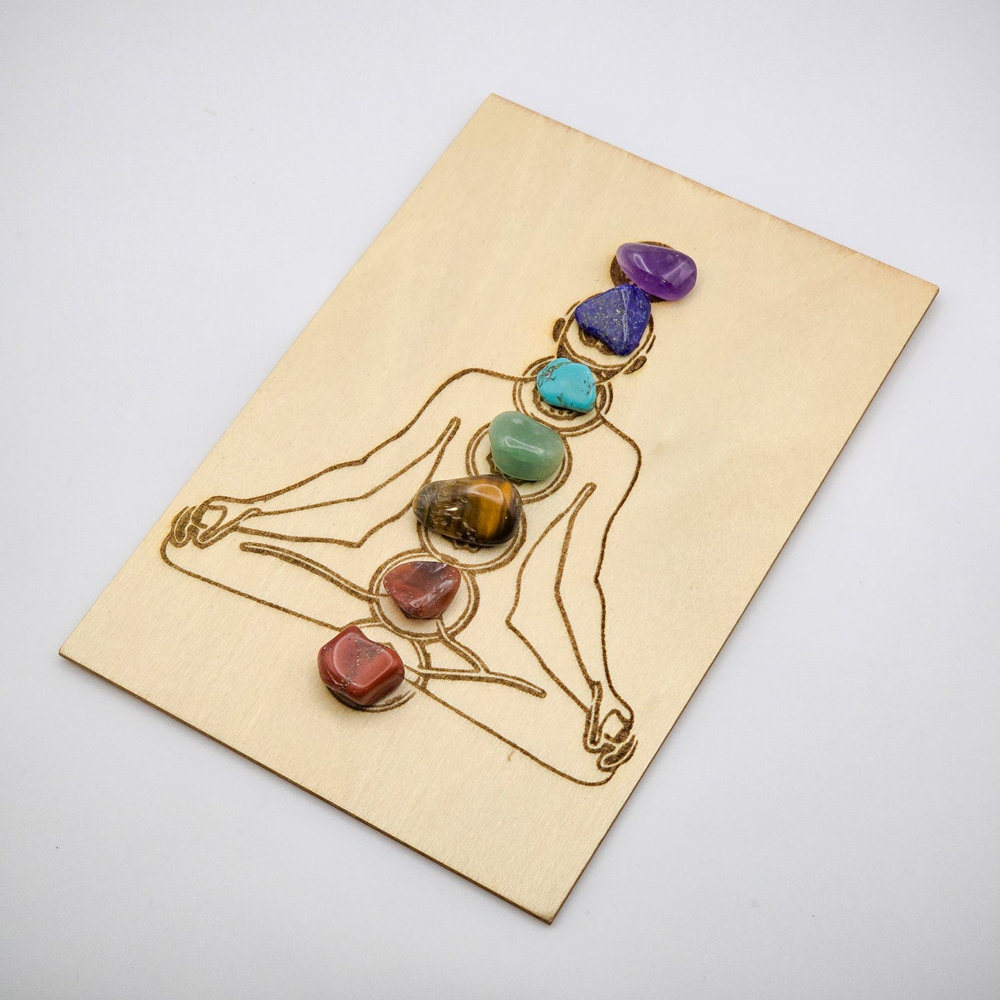 Travel-size chakra meditation grid with stones in place, slightly askew